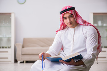 Arab man praying at home