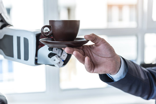 Android is giving beverage to businessman