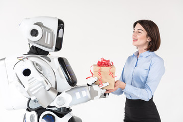 Cheerful girl is receiving present from boyfriend robot