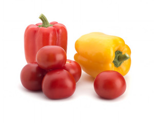 Multi-colored sweet pepper and red tomatoes on a white background