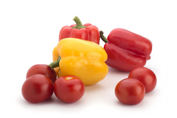 Multi-colored sweet pepper and red tomatoes on a white background