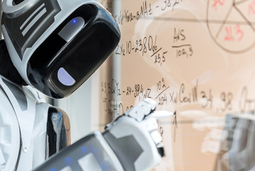 Modern android is standing against glass board