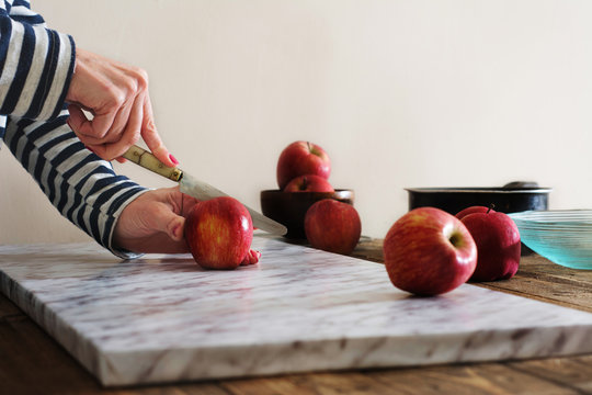 Woman Cutting Apples On The Table