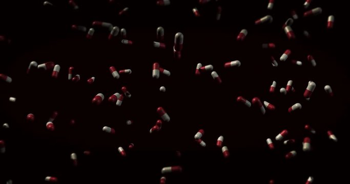 Falling Red and White Capsule pills falling over black - drug overdose concept