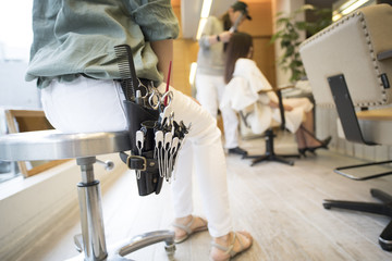 Hairdresser is wearing beauty tool on waist