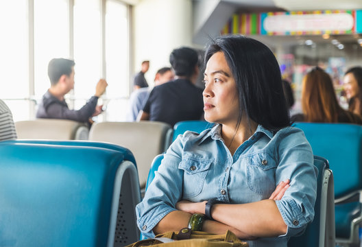 asian Woman waiting for flight at airport terminal for departure Abroad,travel concept