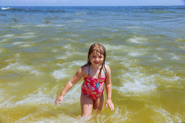 Happy little girl swimming in water