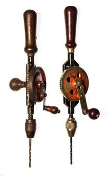 Two vintage hand drills on white background
