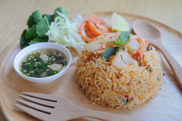 Homemade Chinese fried rice with vegetables, shrimp in spicy taste served on a wooden plate with wooden spoon - 160723070