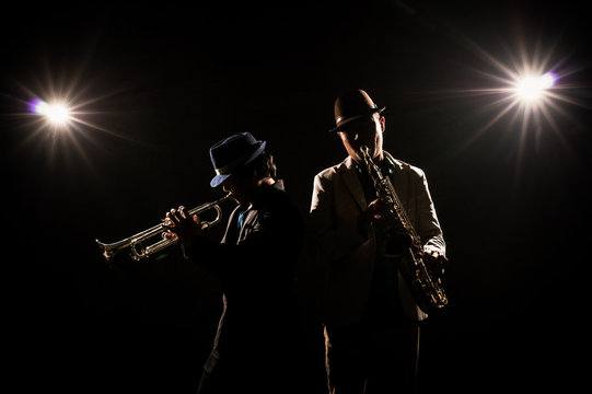 Musician Duo band playing the Trumpet with spot light and lens flare on the stage, musical concept