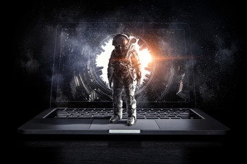 Space explorer and laptop. Mixed media