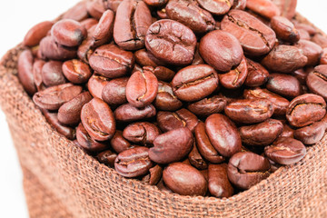 Coffee beans in a burlap bag isolated on white background