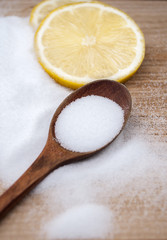 Fototapeta na wymiar salt on the table with lemon and a wooden spoon