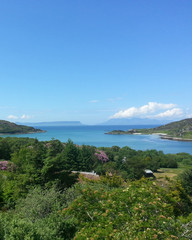 Beautiful scenery of lake clamped between gently sloping hills and clean sky view with little clouds in Scotland.