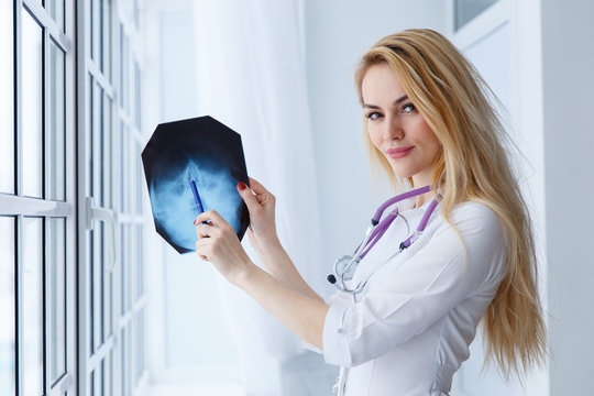 young medical doctor woman pointing on x-ray