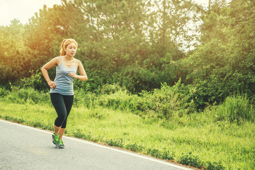 Women exercise on the street. Nature park. Asian women