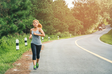 Women exercise on the street. Nature park. Asian women