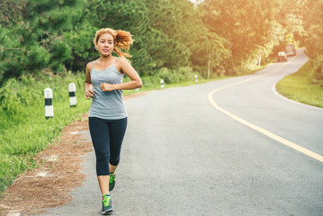 Women exercise on the street. Nature park. Asian women
