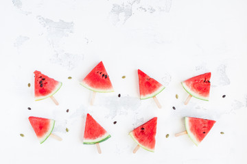 Watermelon popsicle. Sliced watermelon on white background. Flat lay, top view