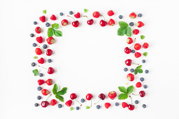 Fruits on white background. Creative frame made of fresh fruits. Strawberry, raspberry, blueberry and sweet cherry. Summer concept. Flat lay, top view, copy space
