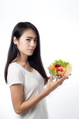 Portrait of  beautiful asian young  woman eating vegetable salad Isolated on white background.