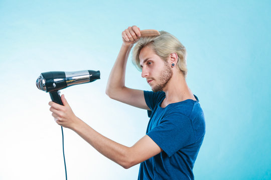 Trendy man with hair dryer