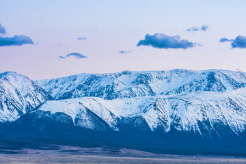 picturesque landscape of snow-covered mountains at sunrise

