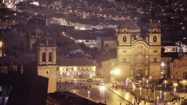 Crowded street, people walking by night at the main square of Colonial city Cusco. 4k