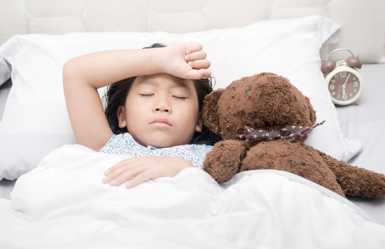 Kid Girl Sleeping And Sick On The Bed With Bear Doll