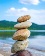 Photo of stones balanced on top of eachother on a beach