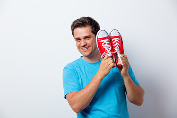 Portrait of young man with red gumshoes