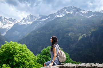 Beautiful tourist girl with backpack in nature