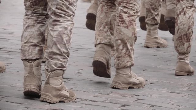 Detail of the soldiers feet and boots marching on parade. 