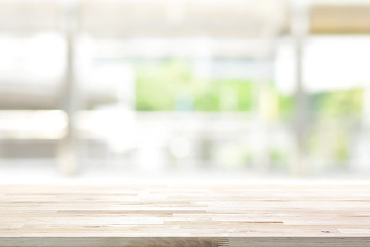 Wood table top on blur kitchen window background