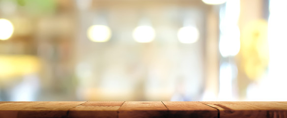 Wood table top on blur restaurant interior background