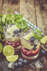Blueberry mojito on rustic wood background