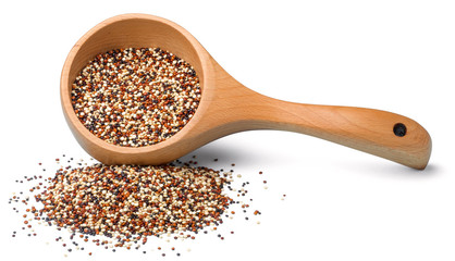 dried quinoa in the wooden spoon on the white background, (large depth of field, taken with tilt shift lens)