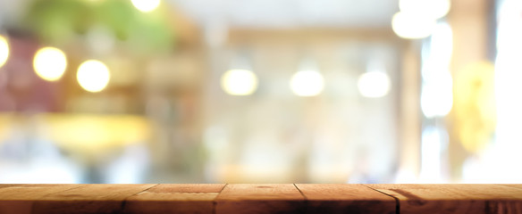 Wood table top on blur restaurant interior background, panoramic banner