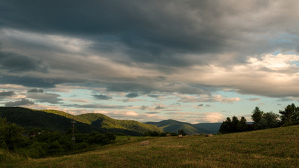 Fototapeta na wymiar Cloudy sunny landscape scene in nature in the summer while hiking 