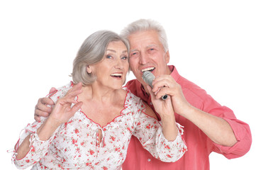 Senior couple singing karaoke