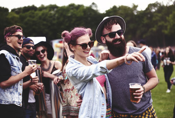 Couple standing in crowd at music festival