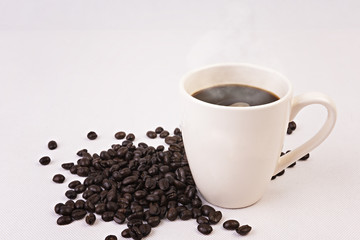 Coffee cup and beans on white background.