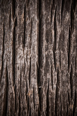 Dark brown scratched wooden cutting board. Wood texture.