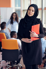 Arabian business woman with hijab holding a folder