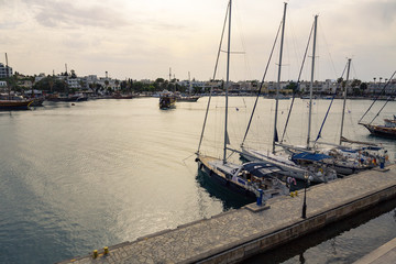 Yacht marina and ferries terminal of Kos town in greece islands of aegean sea. View from above on turquoise water surface of Kos port.