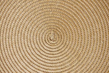 Round woven straw background with the center in the middle of the image