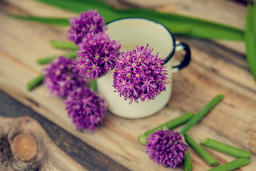Obraz na płótnie Canvas Allium flowers bouquet in a stylish metal decorative vase. Shallow depth of field