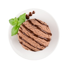 Ice cream brown scoop on plate decorated mint leaves, chocolate sauce, top view, isolated on white background.