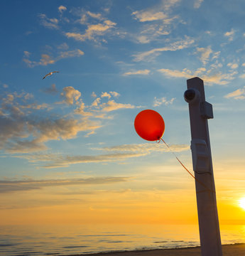 Festive flying ballone at sunrise on a public beach of the Baltic Sea