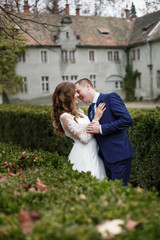 Fototapeta premium Loving couple walking in the park near the castle.
